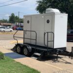 image shows a portable toilet trailer, also known as a luxury restroom trailer or mobile toilet unit