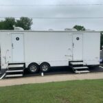 image displays a portable restroom trailer, also known as a mobile toilet or luxury mobile toilet
